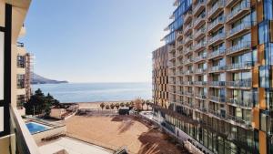 a view of a building with a beach and the ocean at CASA AL MARE RESIDENCE in Bečići