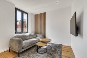 a living room with a couch and a tv at La Lunaria - chambre en colocation in Collonges-sous-Salève