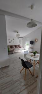 a living room with a table and a couch at Apartmani.Sutomore in Sutomore