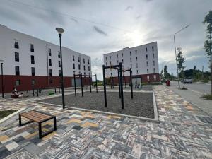 a park with a bench and some buildings at Tirana Airport Apartment in Tirana