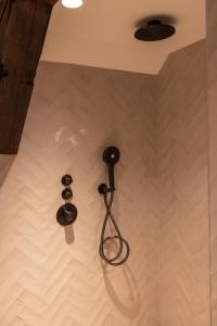 a shower with two shower heads on a wall at Maison Hans in Loenen aan de Vecht +24 photos