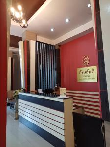 a lobby of a restaurant with a sign on the wall at บ้านสันติ in Chiang Rai