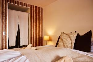 a bedroom with a bed and a window with curtains at Canopy Lodge - Boutique Lodge at Hakuba Cortina in Otari