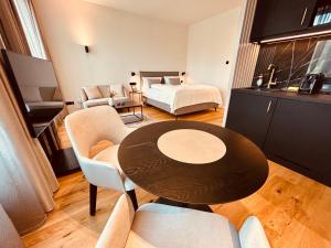 a living room with a table and a bed at The MYDE Hamburg Self Check-in in Hamburg +46 photos