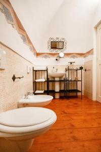 a bathroom with two toilets and a sink at Costiero Luxury Rooms in Gallipoli