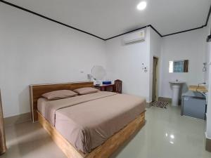 a bedroom with a large bed and a sink at Lake View @Rakthai in Ban Thung Kha Han