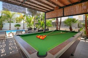 a pool table in a room with a swimming pool at Villa Evergreen - 3bed Bungalow large pool in Protaras