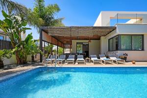 a house with a swimming pool next to a house at Villa Evergreen - 3bed Bungalow large pool in Protaras +26 photos