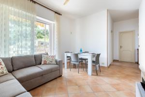 a living room with a couch and a table at Hostdomus-Casa Marais in Finale Ligure