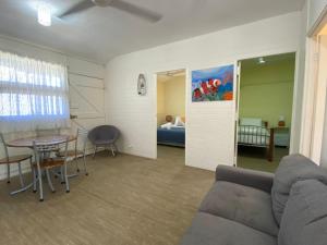 a living room with a couch and a table and a bed at The Captains Manor On Cook 5 in Arcadia