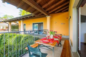 a patio with a table and chairs on a balcony at Villa Mavica in  Monvalle 