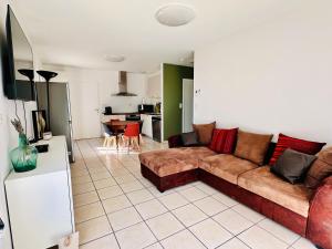 a living room with a couch and a kitchen at L Escapade Rurale in Usseau