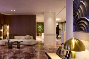 a living room with a couch and a table at Astor Hotel Athens in Athens