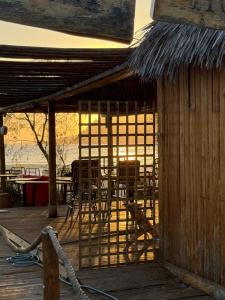 a deck with chairs and tables and a building at Coco-Mat Efterpi House by Plakias Suites in Plakias
