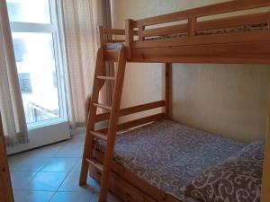 a bedroom with two bunk beds and a window at Apart hotel Alicante in Zatoka