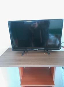 a flat screen tv sitting on top of a wooden stand at Hotel Rustichello in Marina di Campo