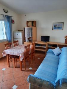 a living room with a table and a couch at Apartman Val in Rogoznica