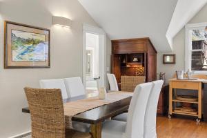 a dining room with a table and white chairs at Peaceful Home-Like Condo - Spacious, Private Deck, Fireplace condo in Telluride +44 photos