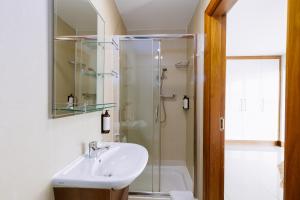 a bathroom with a sink and a shower at Tur an Tsaile - Galway Lakeside Apartments in Galway +8 photos