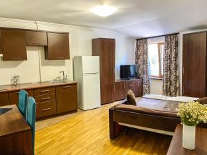 a kitchen with a couch and a table in a room at Shpinat in Odesa