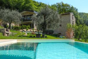 ein großes Schwimmbad vor einem Haus in der Unterkunft Podere Sabaina, Private Villa mit Pool, Seeblick und 3 Wohneinheiten zur Alleinnutzung in Torri del Benaco