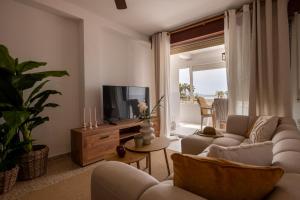 a living room with two couches and a television at Comeback LOOKING FOR THE SUMMER in Motril