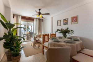 a living room with a table and a dining room at Comeback LOOKING FOR THE SUMMER in Motril +15 photos