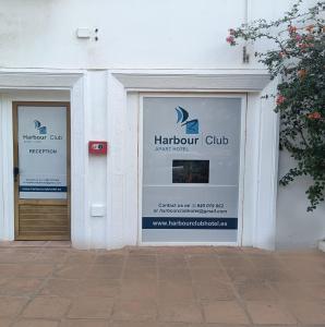 two doors of a storefront with a sign on it at Duquesa Harbour Club Aparthotel in Manilva