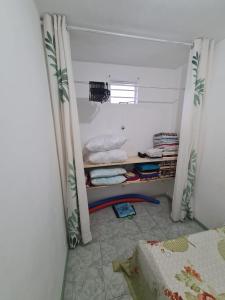 a small room with a bed and a window at Chez Manelle in Grand Baie +5 photos