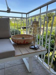 a bath tub sitting on a table on a porch at La Casa di Rorò in Sperlonga