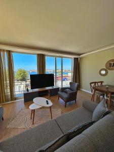 a living room with a couch and a large window at Loca Centre Suites in Bodrum City