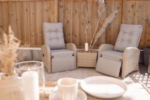 a table with two chairs and a table with candles at Am Rain - Natur und Spa in Winden im Elztal