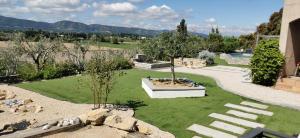 a garden with a park with trees and a fountain at La Bella Vista in Villelaure