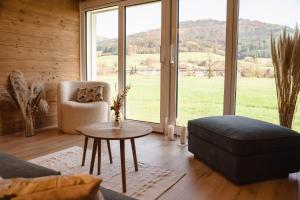 a living room with a couch and a chair and a table at Am Rain - Natur und Spa in Winden im Elztal