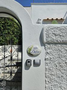 a door with a sign on the side of a building at Villa Dafne in Forio d'Ischia