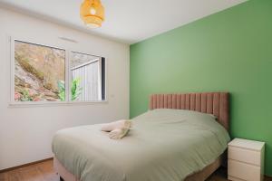 a bedroom with a bed with a stuffed animal on it at Gites des Pierres Sonnantes in Saint-Cast-le-Guildo