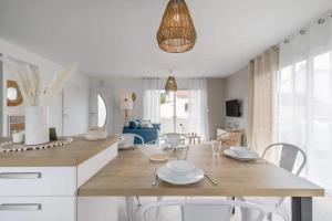a kitchen and living room with a table and chairs at Clair Jeanne - 900m plage - Parking in Notre-Dame-de-Monts