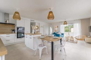 a kitchen with a table and chairs in a room at Clair Jeanne - 900m plage - Parking in Notre-Dame-de-Monts +16 photos