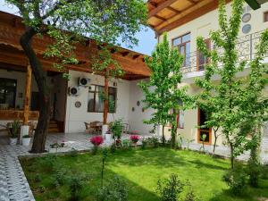 a courtyard of a house with a garden at Chorsu Inn in Tashkent