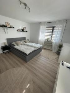 a large bedroom with a bed and a window at Apartment Anna in Inzigkofen
