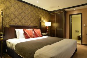 Postel nebo postele na pokoji v ubytování Ramada by Wyndham Songdo