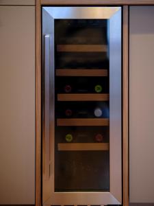a cabinet with a glass door with food inside at Luxusowy Apartament Staszica in Koszalin