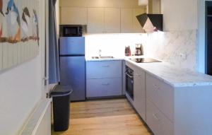 a kitchen with a blue refrigerator and a sink at Awesome Home In Vlagtwedde With Wifi in Vlagtwedde