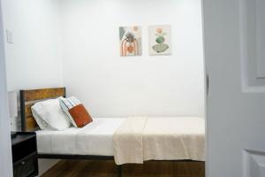 a bedroom with a bed with white sheets and pillows at The Jaxon in West Palm Beach +58 photos