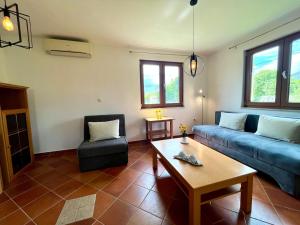 a living room with a blue couch and a table at Villa FIAMMA MEDJUGORJE in Međugorje