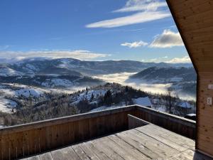 a view of the mountains from the balcony of a cabin at Casa Nordica - La noi la munte in Mătişeşti