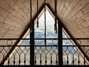 a window in a building with a view of a mountain at Casa Nordica - La noi la munte in Mătişeşti