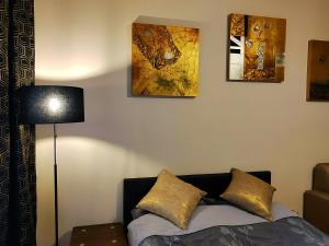 a living room with a couch and paintings on the wall at Apartament TwojaNoc in Mielec