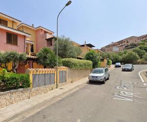 a street with cars parked on the side of the road at da Bonny in Villasimius
