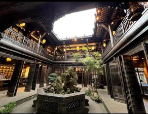 a large building with a fountain in the middle of it at Kelly Jinyue Hotel in Chengdu